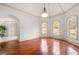 Bright living room with hardwood floors, arched windows, and neutral color scheme at 4233 Sandstone Shores Dr, Stonecrest, GA 30038