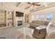 Inviting living room with a fireplace, built-in shelves, and a plush sectional couch at 4233 Sandstone Shores Dr, Stonecrest, GA 30038