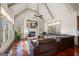 Inviting living room featuring vaulted ceilings, large windows, a fireplace, and comfortable seating, perfect for relaxation and gatherings at 4233 Sandstone Shores Dr, Stonecrest, GA 30038