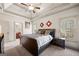 Tranquil main bedroom featuring a tray ceiling, carpet, and an ensuite bathroom at 4233 Sandstone Shores Dr, Stonecrest, GA 30038