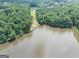 Scenic lake view, with house and lawn visible in the distance at 4233 Sandstone Shores Dr, Stonecrest, GA 30038