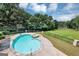 Backyard view of a private, in-ground pool with an attached hot tub at 4233 Sandstone Shores Dr, Stonecrest, GA 30038