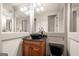 Stylish powder room with a vessel sink, dark countertop, and wood cabinetry at 4233 Sandstone Shores Dr, Stonecrest, GA 30038