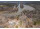 A high aerial view shows a lake house settled among trees with lake access on a large river at 650 Malcom Rd, Covington, GA 30014