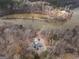 Stunning aerial view of a home situated close to a calm river and a dense forest at 650 Malcom Rd, Covington, GA 30014