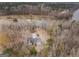 A high aerial view shows the lake house settled among trees with lake access on a large river at 650 Malcom Rd, Covington, GA 30014