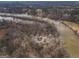 Overhead view displays a home near a serene river, enveloped by woodland, perfect for outdoor living at 650 Malcom Rd, Covington, GA 30014