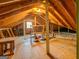 Unfinished attic space with exposed wood beams and plywood flooring showing potential for storage at 650 Malcom Rd, Covington, GA 30014