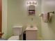 Simple bathroom with a toilet, sink, and towel rack at 650 Malcom Rd, Covington, GA 30014