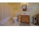 Bathroom featuring yellow walls, standard sink, toilet, shower with curtain, and neutral flooring at 650 Malcom Rd, Covington, GA 30014