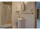 Standard bathroom features a shower, vanity, and mirror; adjacent to open doorway at 650 Malcom Rd, Covington, GA 30014