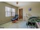 Bedroom features a chair, natural light through the window, and warm lighting, creating a cozy and inviting space at 650 Malcom Rd, Covington, GA 30014