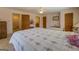 Bedroom with carpet, featuring a bed with a floral comforter, ceiling fan, and natural light at 650 Malcom Rd, Covington, GA 30014