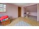 Bedroom with a window and door, featuring pink walls and a wood chest topped with blankets at 650 Malcom Rd, Covington, GA 30014