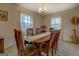 Formal dining room featuring traditional wood table and chairs under an elegant chandelier at 650 Malcom Rd, Covington, GA 30014