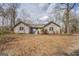 An exterior front view shows a one-story home with minimal landscaping and a red front door at 650 Malcom Rd, Covington, GA 30014