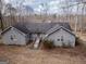 Charming single-story home with gray facade and a welcoming wooden bridge leading to the front door at 650 Malcom Rd, Covington, GA 30014