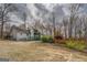 Exterior view of the home showing the upper deck, lower ramp, and trimmed garden at 650 Malcom Rd, Covington, GA 30014