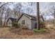 Side exterior of the home showing the stucco and trimmed garden at 650 Malcom Rd, Covington, GA 30014