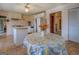 Bright kitchen with white appliances, island, and dining area with floral tablecloth at 650 Malcom Rd, Covington, GA 30014