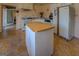 A kitchen features an island, white appliances, light wood floors, and light pink walls at 650 Malcom Rd, Covington, GA 30014