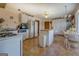 This kitchen features white appliances and cabinets, an island, and a small dining table at 650 Malcom Rd, Covington, GA 30014