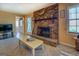 The living room features a brick fireplace, a ceiling fan, and an entrance into the kitchen at 650 Malcom Rd, Covington, GA 30014