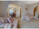 Cozy living room with archways, patterned sofas, carpet flooring, and an open view to the dining area at 650 Malcom Rd, Covington, GA 30014