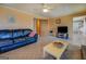 Living room featuring carpet, sofa, and an adjacent kitchen and dining area at 650 Malcom Rd, Covington, GA 30014