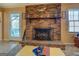 The living room has a brick fireplace, a ceiling fan, and a door to the outside deck at 650 Malcom Rd, Covington, GA 30014