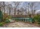 Fenced in backyard pool with wood surround and adjacent patio area, perfect for outdoor enjoyment at 650 Malcom Rd, Covington, GA 30014