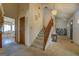 Carpeted staircase with wooden banister, leading to the upper level of the home at 650 Malcom Rd, Covington, GA 30014