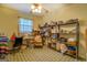 Storage room featuring a ceiling fan and filled with items on shelving units and on the floor at 650 Malcom Rd, Covington, GA 30014