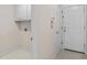 Bright laundry room with white cabinets and tiled flooring offers practicality and convenience at 807 Ivy Ridge Dr, Loganville, GA 30052