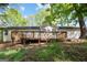 Home's backyard features a wooden deck perfect for outdoor relaxation and entertaining with mature trees at 1620 Summit Rdg, Auburn, GA 30011