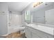 Bathroom features a single sink vanity, window, tub and shower combo, and neutral paint at 1620 Summit Rdg, Auburn, GA 30011