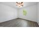 Cozy bedroom features wood-look flooring, white walls, and natural light from a window view at 1620 Summit Rdg, Auburn, GA 30011