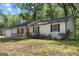 Charming single-story home with flowering bushes in the front and white painted siding at 1620 Summit Rdg, Auburn, GA 30011