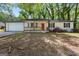 Charming single-story home featuring a quaint front porch and a vibrant red front door at 1620 Summit Rdg, Auburn, GA 30011