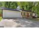Angle shot of a ranch-style home featuring an attached garage and a red front door at 1620 Summit Rdg, Auburn, GA 30011