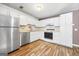 Bright kitchen featuring white cabinets, hardwood flooring and stainless steel appliances at 1620 Summit Rdg, Auburn, GA 30011
