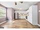 Bright kitchen with hardwood flooring, white cabinets and stainless appliances at 1620 Summit Rdg, Auburn, GA 30011