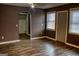 Empty living room featuring hardwood floors, a ceiling fan, two windows, and neutral colored walls at 1620 Summit Rdg, Auburn, GA 30011