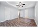 A spacious main bedroom features wood-look flooring, a ceiling fan, and ample natural light at 1620 Summit Rdg, Auburn, GA 30011