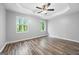 A main bedroom boasts neutral walls, wood-look floors, tray ceiling, and bright, sunlit windows at 1620 Summit Rdg, Auburn, GA 30011