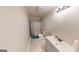 Neutral bathroom featuring modern vanity with sink, toilet, and shower-tub combination at 357 Karen Ct, Lawrenceville, GA 30046