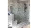 Modern bathroom features a glass shower with marble-patterned tile and a built-in shower bench at 1848 Eastmore Ave, Conyers, GA 30094