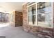 Back porch featuring stone columns and ceiling fan, perfect for relaxing and enjoying the outdoors at 430 Gregory Rd, Covington, GA 30014