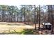 Large, well-maintained backyard featuring mature trees, green grass, and a charming shed at 430 Gregory Rd, Covington, GA 30014