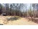 Spacious backyard with mature trees and a small shed, ideal for outdoor activities and relaxation at 430 Gregory Rd, Covington, GA 30014